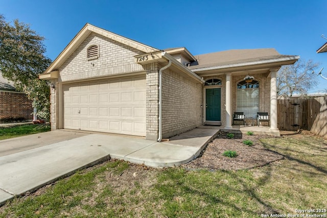 single story home featuring fence, a porch, concrete driveway, a garage, and brick siding