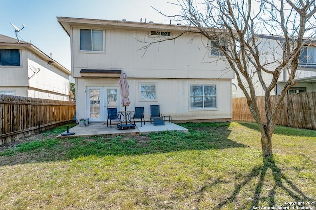 back of property featuring a patio area, a fenced backyard, and a yard