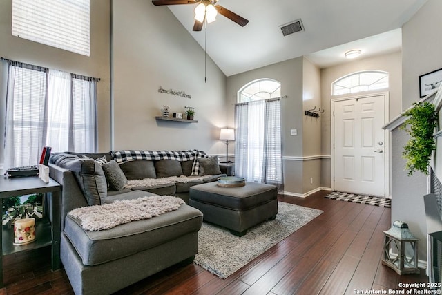 living room with visible vents, dark wood-type flooring, baseboards, high vaulted ceiling, and a ceiling fan