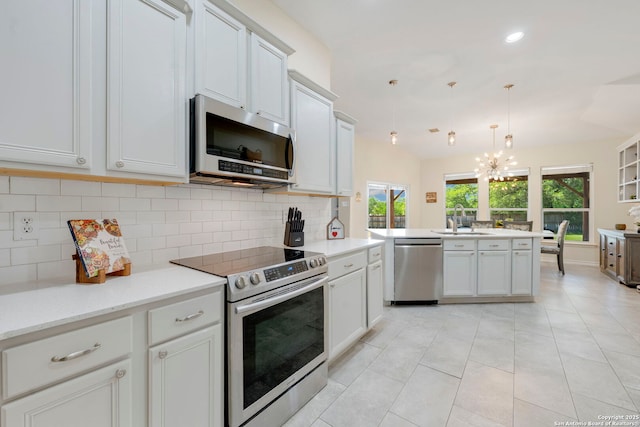 14019 Tahoe Vis, San Antonio, TX 78253 - kitchen with a notable chandelier, a sink, light countertops, appliances with stainless steel finishes, and backsplash
