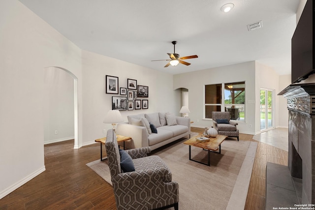 14019 Tahoe Vis, San Antonio, TX 78253 - living room featuring a fireplace, a ceiling fan, visible vents, arched walkways, and wood finished floors