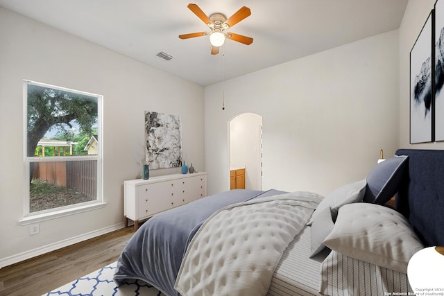 14019 Tahoe Vis, San Antonio, TX 78253 - bedroom featuring visible vents, baseboards, arched walkways, a ceiling fan, and wood finished floors