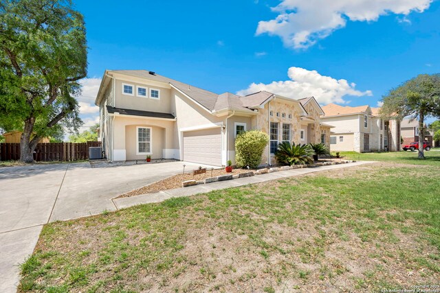 14019 Tahoe Vis, San Antonio, TX 78253 - view of front of home featuring stucco siding, driveway, a front yard, central AC unit, and fence