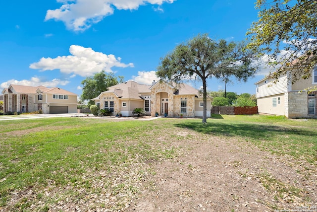 14019 Tahoe Vis, San Antonio, TX 78253 - view of front facade featuring a residential view, stone siding, a front lawn, an attached garage, and fence
