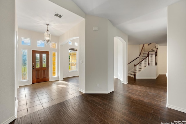 14019 Tahoe Vis, San Antonio, TX 78253 - foyer featuring dark wood-type flooring, arched walkways, visible vents, stairs, and a notable chandelier