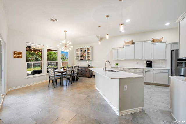 14019 Tahoe Vis, San Antonio, TX 78253 - kitchen with stainless steel fridge with ice dispenser, an inviting chandelier, light countertops, a sink, and backsplash