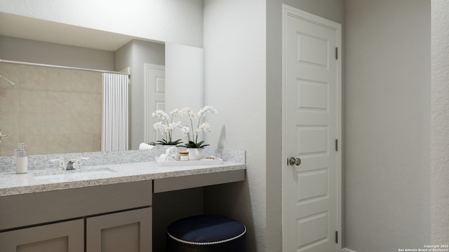 bathroom featuring vanity, a shower with curtain, and a textured wall