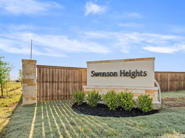 community sign featuring a yard and fence