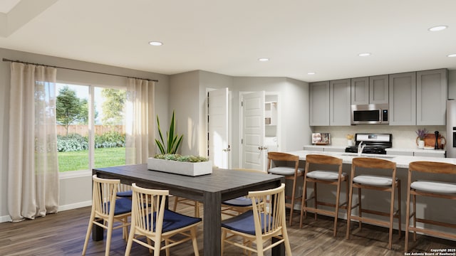 dining room featuring dark wood finished floors, recessed lighting, and baseboards