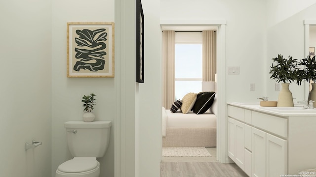 ensuite bathroom with toilet, double vanity, wood finished floors, ensuite bath, and a sink