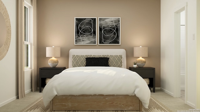 bedroom featuring light colored carpet and baseboards