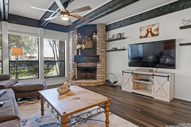 217 T Bar M # B21, New Braunfels, TX 78132 - living area featuring a stone fireplace, beam ceiling, wood finished floors, and baseboards
