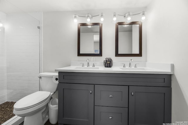 217 T Bar M # B21, New Braunfels, TX 78132 - bathroom featuring double vanity, toilet, tiled shower, and a sink