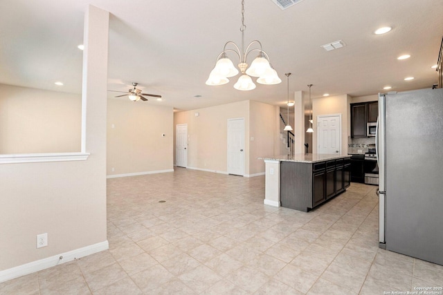 12604 Brite Rnch, San Antonio, TX 78245 - kitchen featuring pendant lighting, ceiling fan with notable chandelier, a center island, appliances with stainless steel finishes, and baseboards