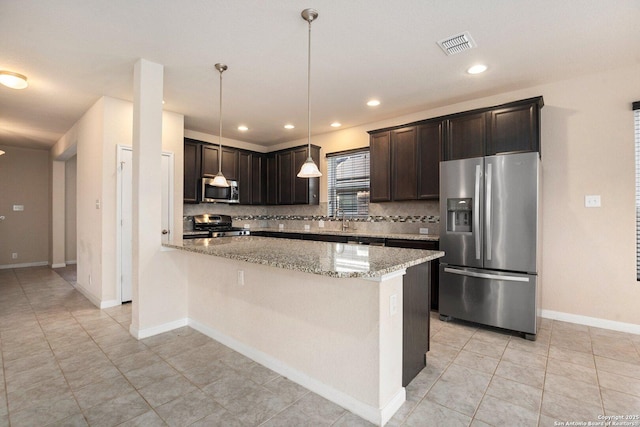 12604 Brite Rnch, San Antonio, TX 78245 - kitchen with dark brown cabinets, visible vents, light stone counters, and appliances with stainless steel finishes
