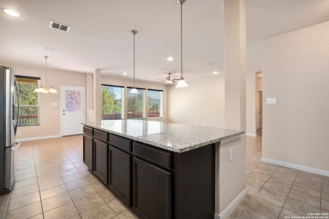 12604 Brite Rnch, San Antonio, TX 78245 - kitchen featuring a wealth of natural light, visible vents, ceiling fan with notable chandelier, and freestanding refrigerator