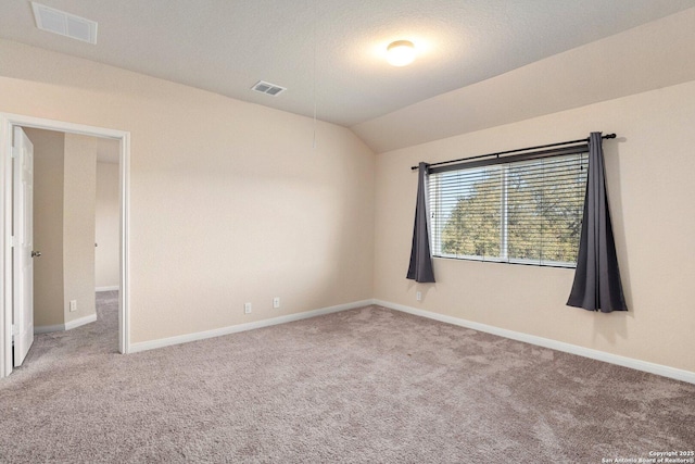 12604 Brite Rnch, San Antonio, TX 78245 - carpeted spare room featuring visible vents, lofted ceiling, a textured ceiling, and baseboards