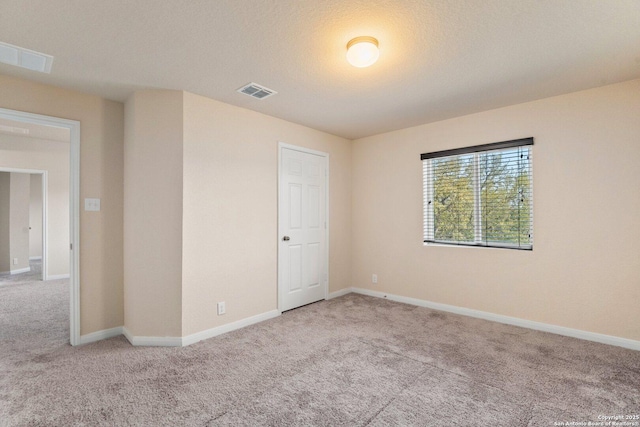 12604 Brite Rnch, San Antonio, TX 78245 - unfurnished bedroom with visible vents, a textured ceiling, baseboards, and carpet