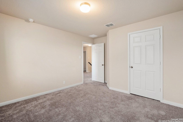 12604 Brite Rnch, San Antonio, TX 78245 - unfurnished bedroom featuring visible vents, a textured ceiling, baseboards, and carpet floors