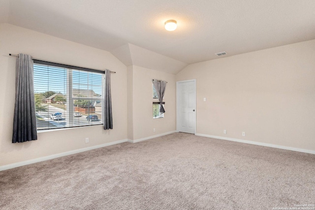 12604 Brite Rnch, San Antonio, TX 78245 - spare room with light carpet, visible vents, baseboards, and lofted ceiling