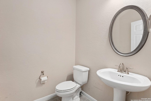 12604 Brite Rnch, San Antonio, TX 78245 - bathroom with a sink, baseboards, toilet, and tile patterned flooring