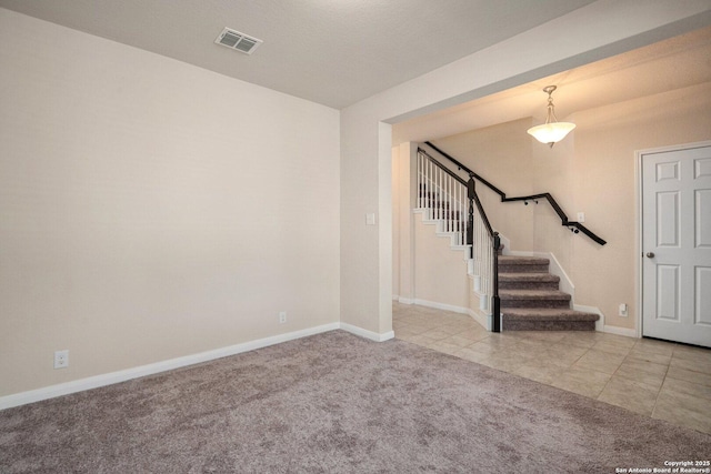 12604 Brite Rnch, San Antonio, TX 78245 - carpeted empty room featuring tile patterned floors, visible vents, baseboards, and stairway