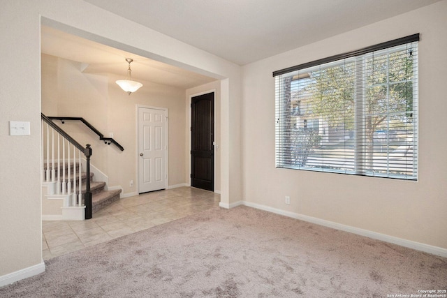12604 Brite Rnch, San Antonio, TX 78245 - carpeted entrance foyer featuring tile patterned flooring, stairway, and baseboards