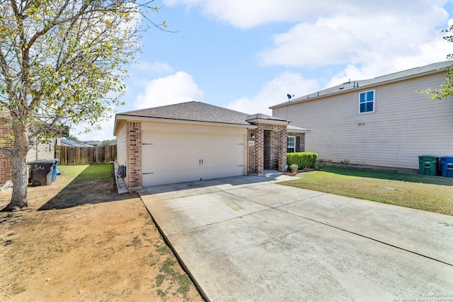 exterior space with a garage, brick siding, concrete driveway, and a front lawn