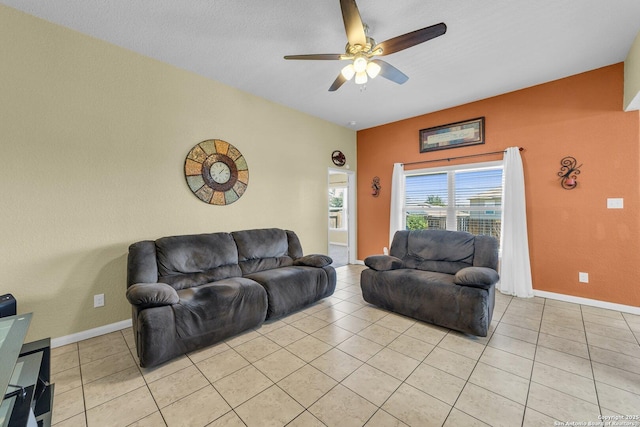 living area with light tile patterned floors, baseboards, and ceiling fan