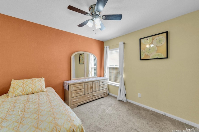 bedroom with baseboards, light carpet, and ceiling fan