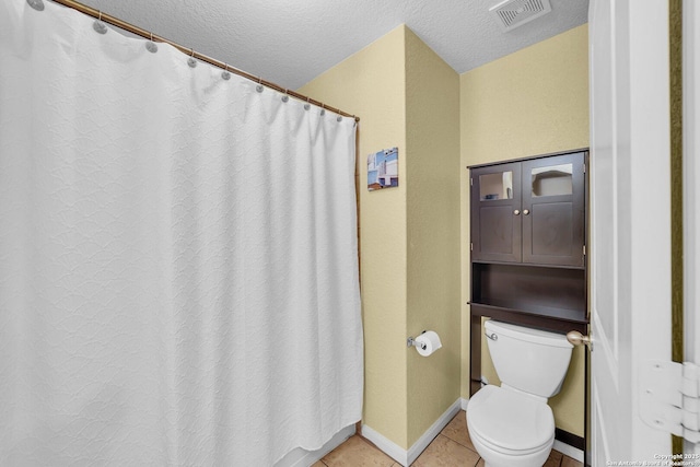 full bath with baseboards, visible vents, a textured ceiling, tile patterned floors, and toilet