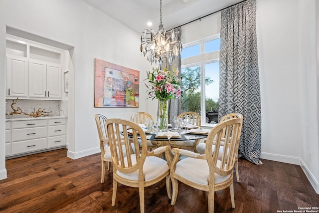 dining space with baseboards, an inviting chandelier, and dark wood finished floors