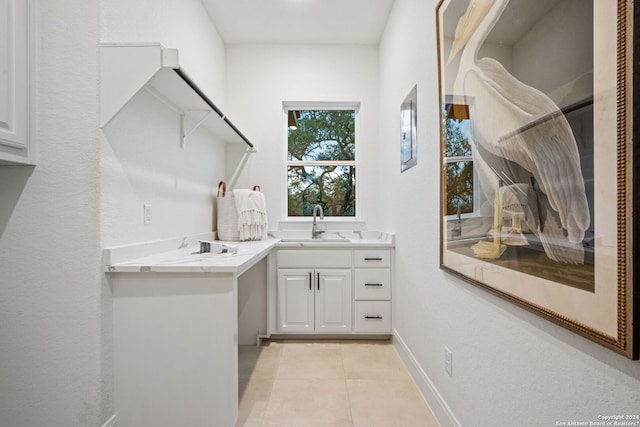 bathroom with vanity, tile patterned floors, and baseboards