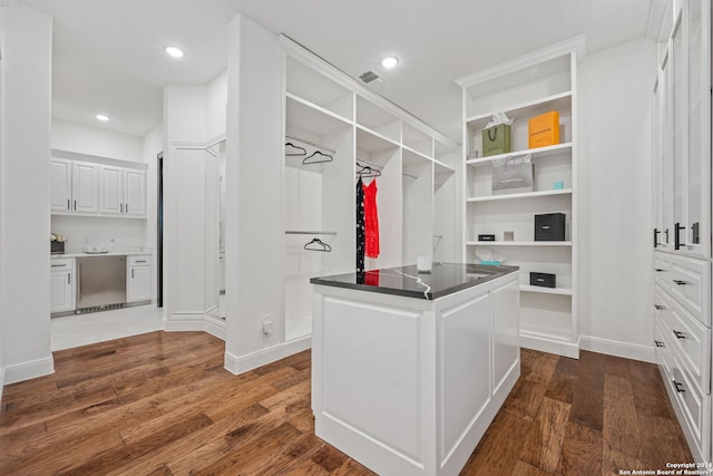 spacious closet featuring visible vents and dark wood finished floors