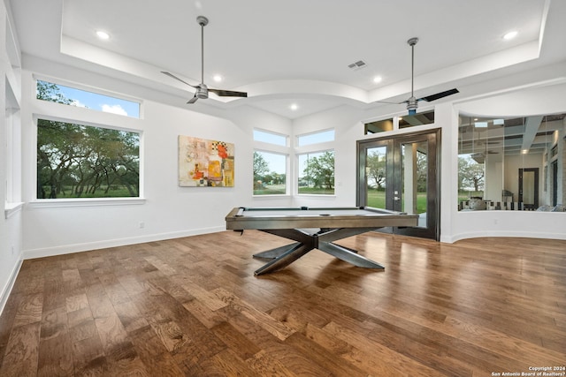 rec room featuring baseboards, a ceiling fan, a tray ceiling, and wood finished floors