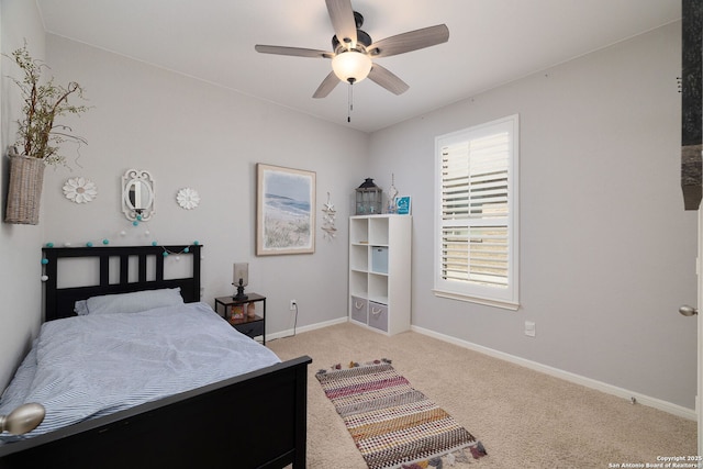 bedroom with baseboards, light colored carpet, and a ceiling fan