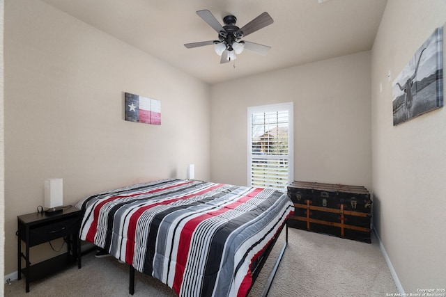 carpeted bedroom with a ceiling fan and baseboards