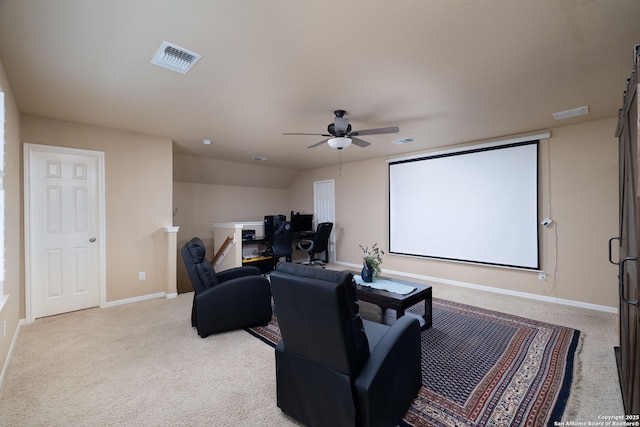 carpeted home theater with visible vents, baseboards, and a ceiling fan