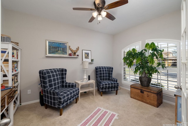 sitting room with carpet flooring, a ceiling fan, and baseboards