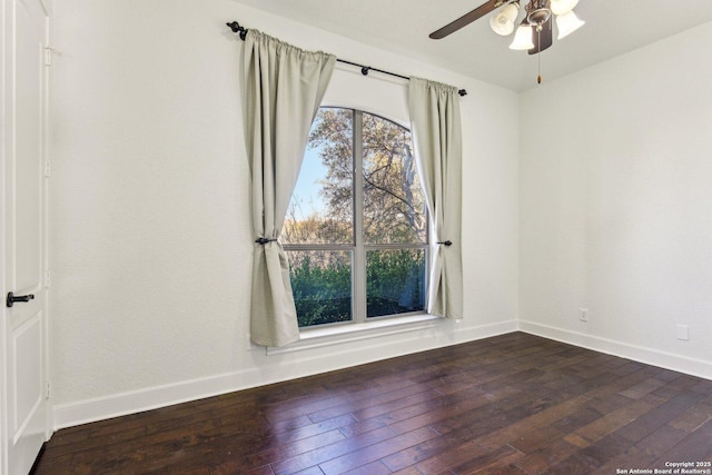 spare room featuring ceiling fan, baseboards, and wood-type flooring