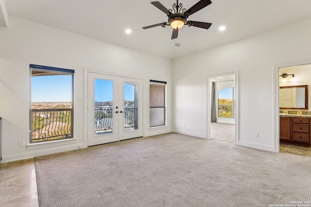 unfurnished bedroom featuring light colored carpet, french doors, multiple windows, and access to outside