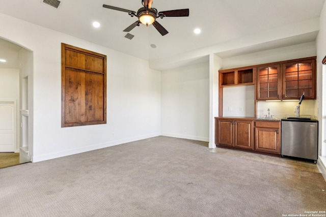 unfurnished living room featuring recessed lighting, light colored carpet, and arched walkways