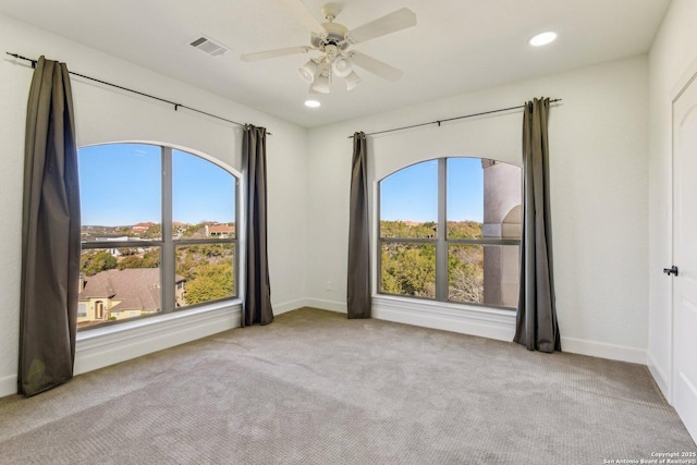 empty room featuring recessed lighting, visible vents, a healthy amount of sunlight, and carpet flooring