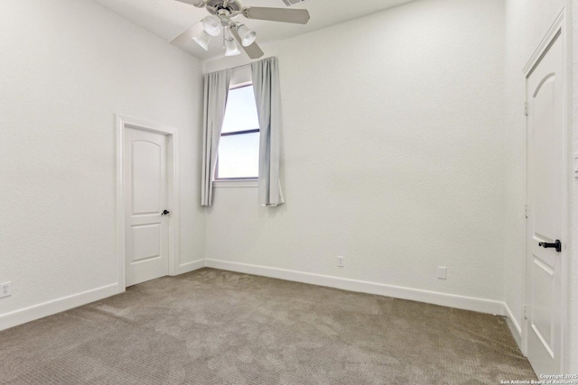 carpeted empty room with baseboards and ceiling fan