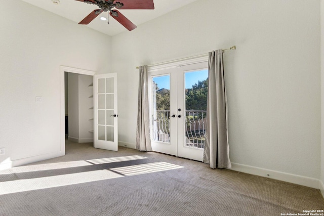 carpeted empty room with french doors, baseboards, and a ceiling fan