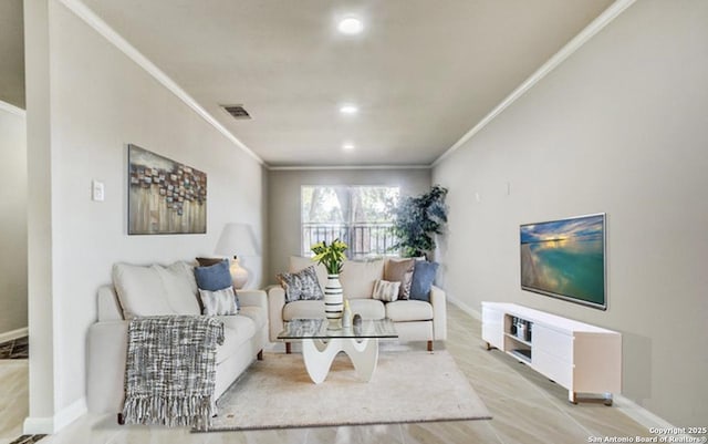 living room with recessed lighting, visible vents, baseboards, and crown molding