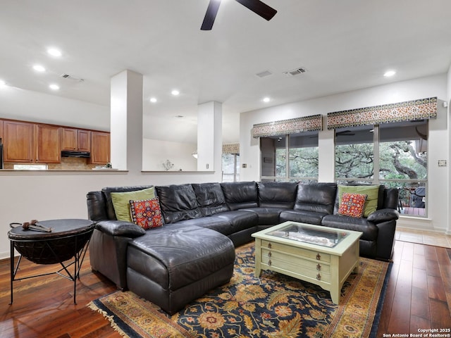 living room with visible vents, recessed lighting, and wood-type flooring