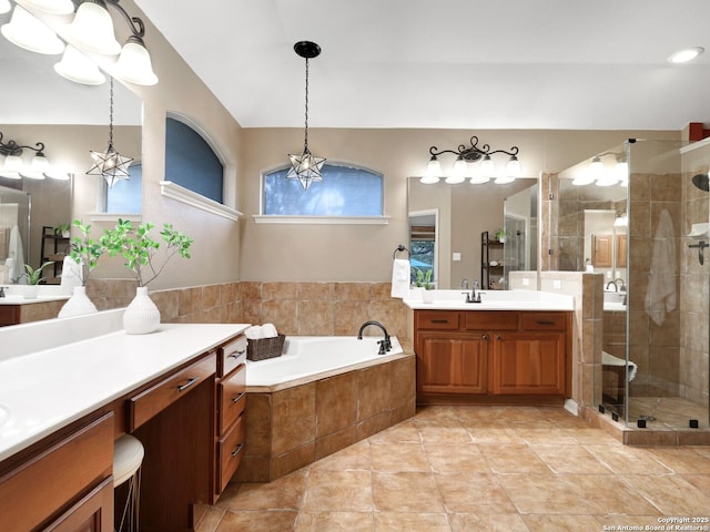 full bathroom with a sink, a shower stall, a garden tub, and two vanities