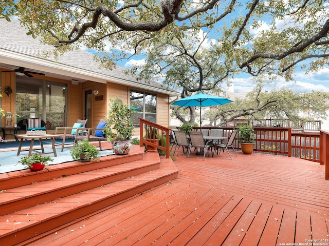 wooden deck featuring outdoor dining area