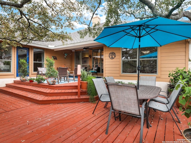 deck featuring outdoor dining area and ceiling fan